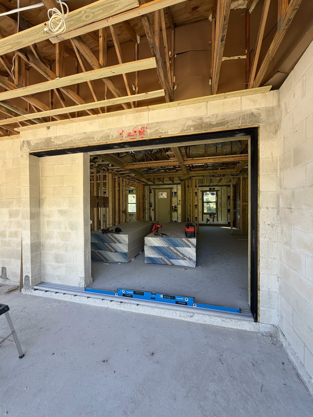 Wide block opening prepared for a sliding glass door with a level on the sill, North Port