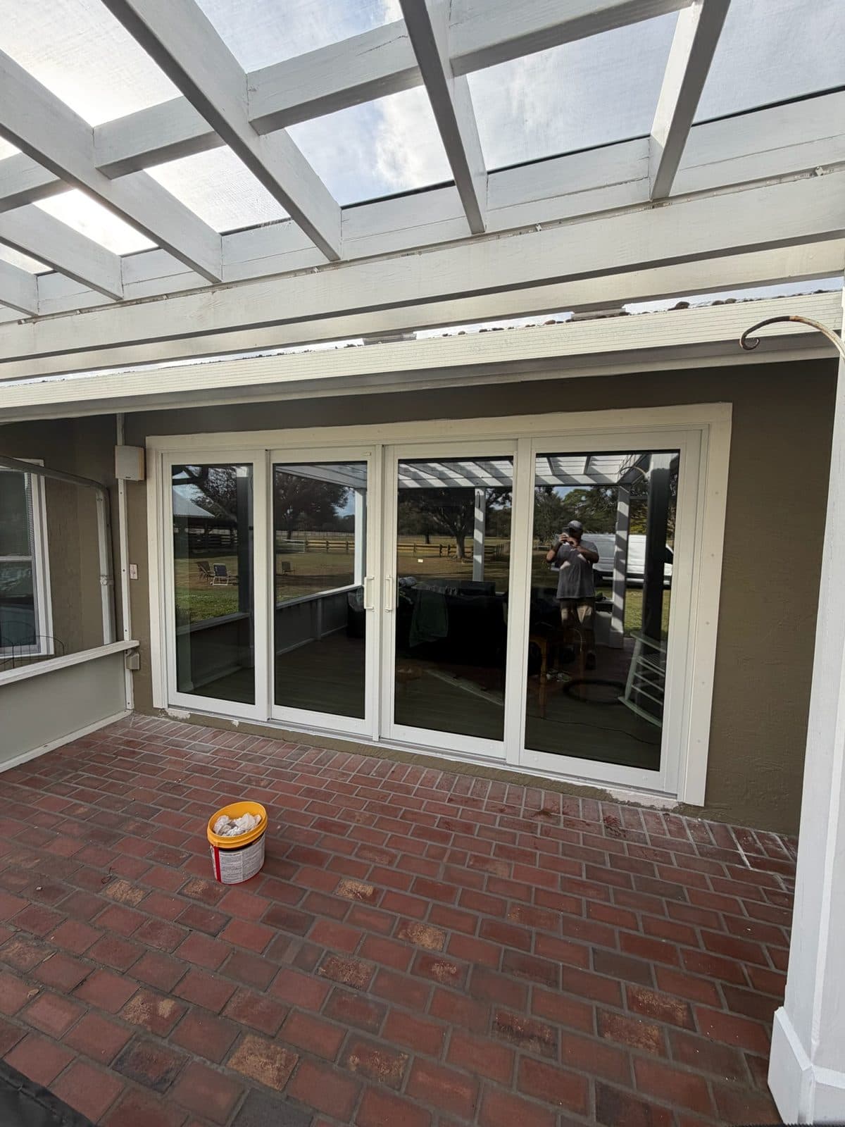 Four-panel sliding glass door opening onto a covered brick-paver patio, Sarasota County