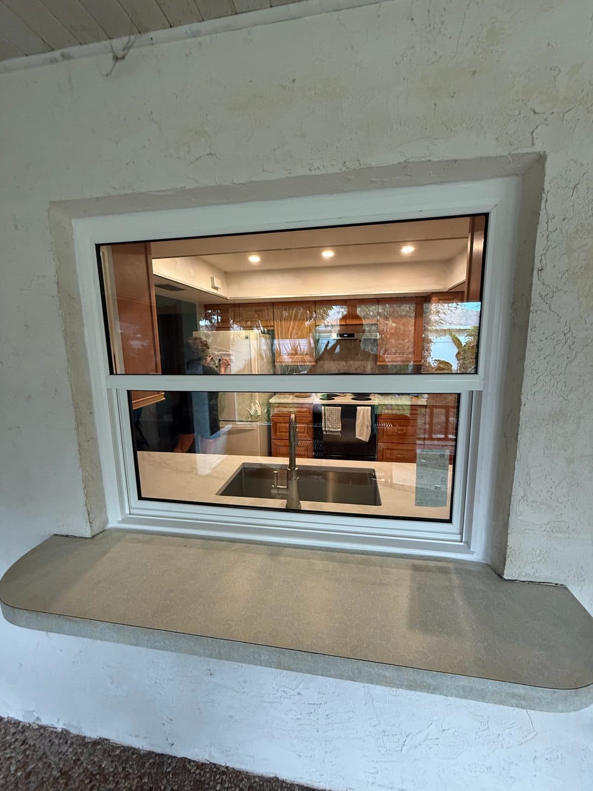 Pass-through window with a wide ledge seen from the lanai side, Sarasota