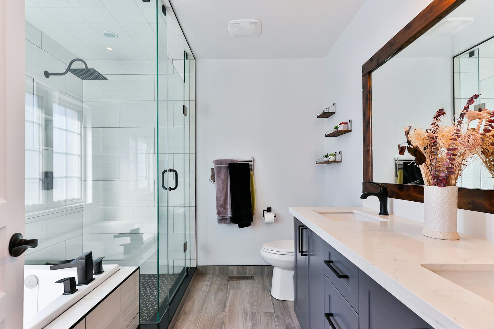 Remodeled bathroom with a frameless glass shower and floating vanity