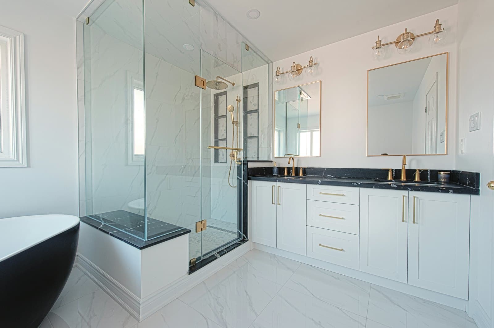 Spa-style bathroom with a freestanding tub beside a glass-enclosed shower