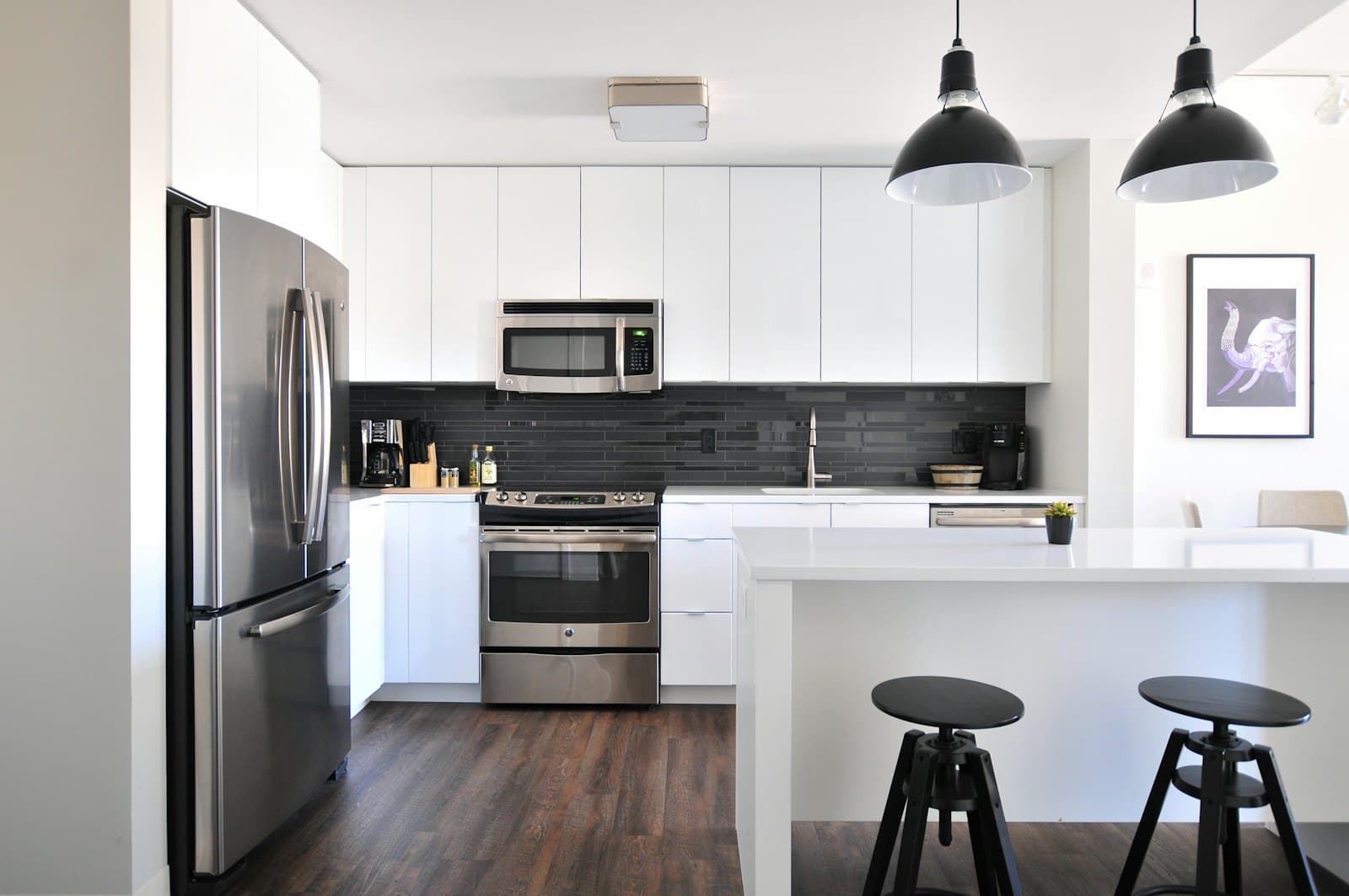 Modern kitchen with gray cabinets and a stainless French-door refrigerator