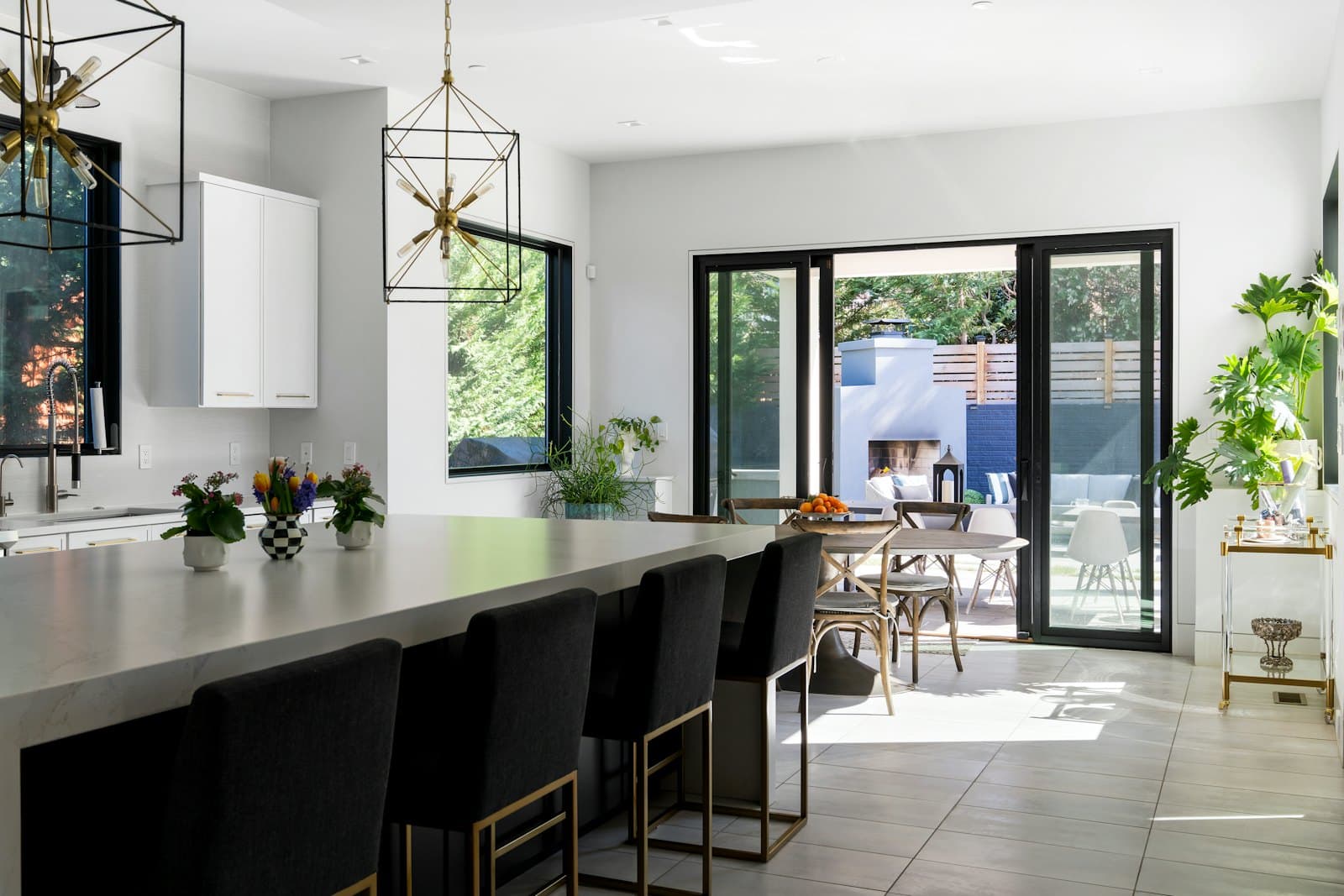 Open-concept kitchen with a large island that flows out to a covered patio