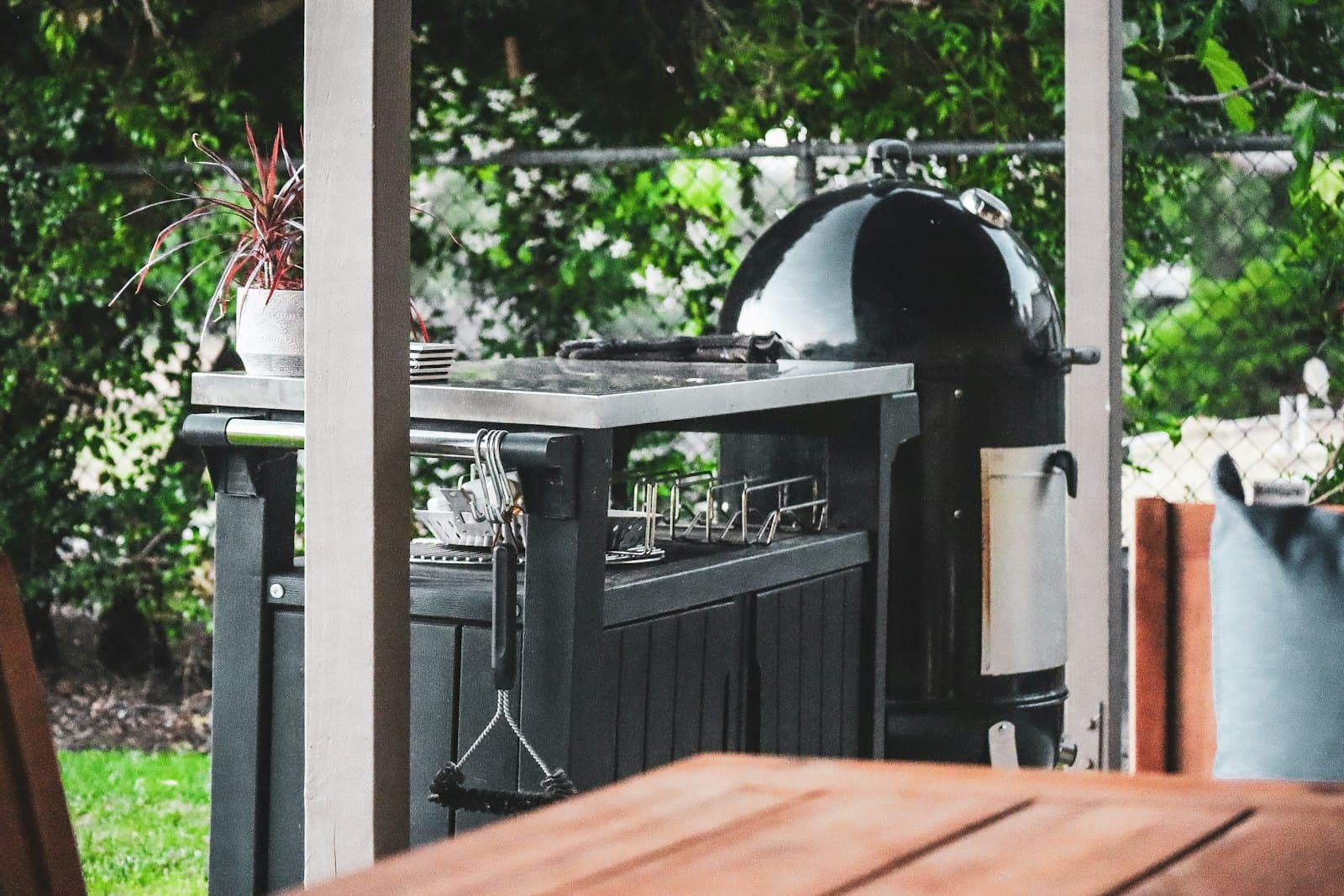 Built-in grill station surrounded by tropical plants