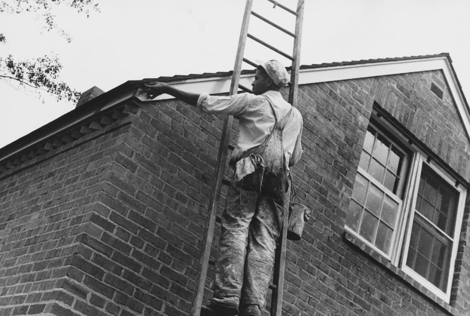 Painter working on the exterior of a house